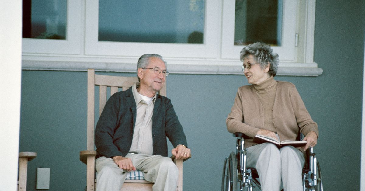 two elderly people sitting on front porch - Maple Care Homes residential assisted living near Burnsville
