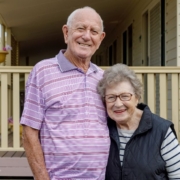 elderly couple standing in front of home - Maple Care Homes residential assisted living near maple grove